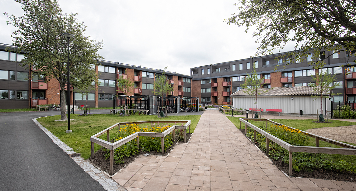 Innergård med gräsmatta och tegelhus på Varbergagatan 85-100